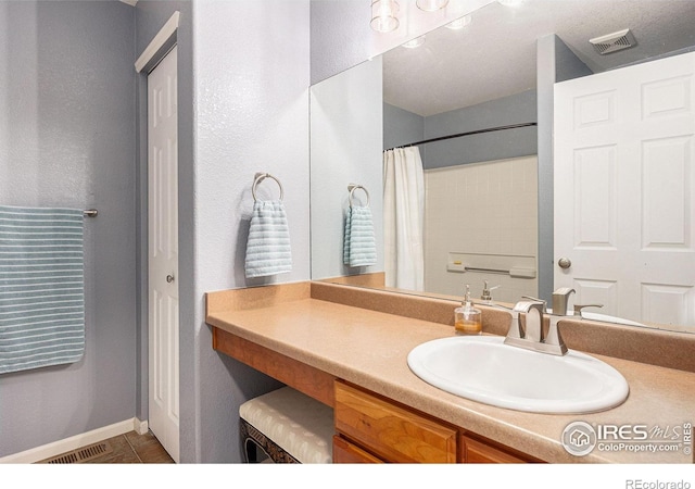18656 Kelly Pl, Denver, CO 80249 - bathroom with vanity, a shower with curtain, and baseboards