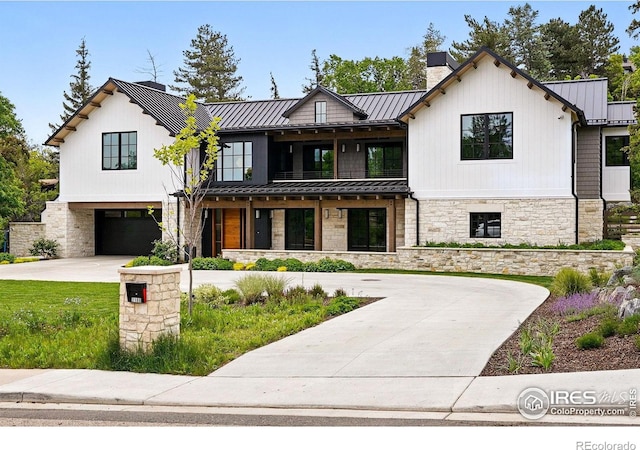 2100 Kohler Dr, Boulder, CO 80305 - modern farmhouse style home with a standing seam roof, stone siding, and driveway
