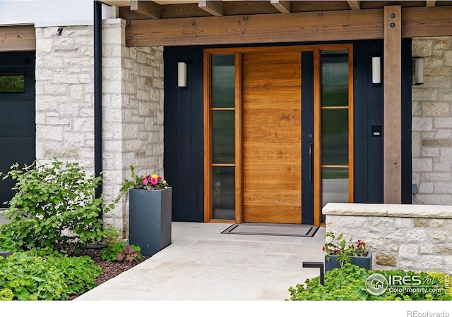 2100 Kohler Dr, Boulder, CO 80305 - view of exterior entry featuring stone siding and covered porch