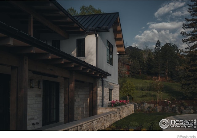 2100 Kohler Dr, Boulder, CO 80305 - view of side of property with a standing seam roof, metal roof, stone siding, and a lawn