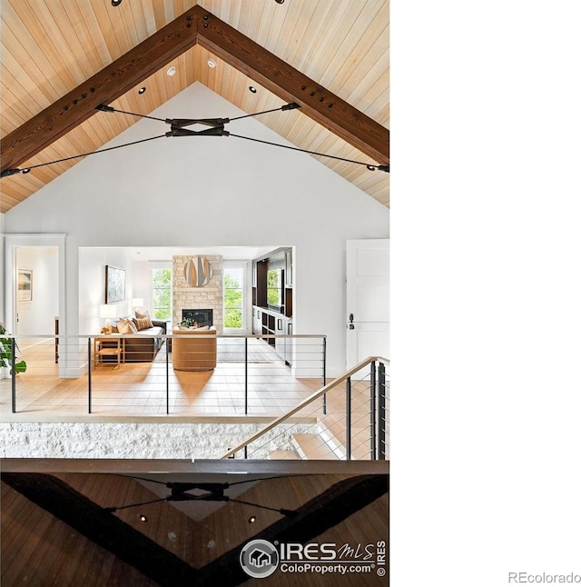 2100 Kohler Dr, Boulder, CO 80305 - living area featuring wood ceiling with exposed beams, a fireplace, and high vaulted ceiling