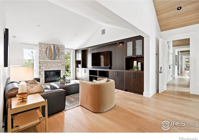2100 Kohler Dr, Boulder, CO 80305 - living room with vaulted ceiling, light wood-style floors, and a stone fireplace
