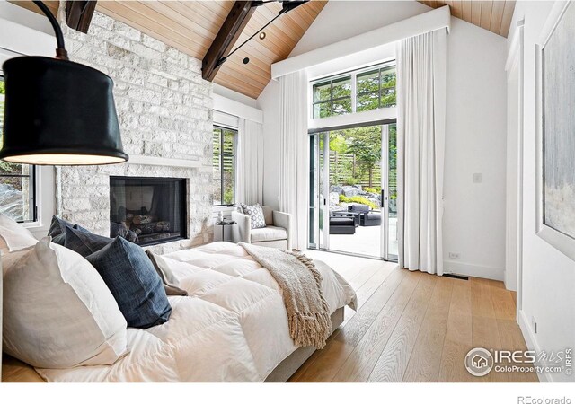 2100 Kohler Dr, Boulder, CO 80305 - bedroom with wooden ceiling with exposed beams, access to outside, hardwood / wood-style floors, a stone fireplace, and high vaulted ceiling