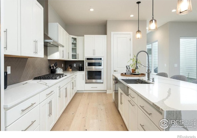 730 Promenade Dr, Superior, CO 80027 - kitchen featuring appliances with stainless steel finishes, light wood finished floors, a sink, white cabinets, and recessed lighting