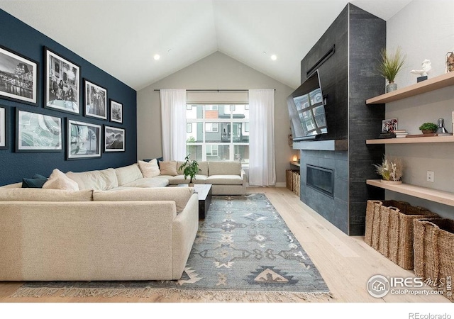 730 Promenade Dr, Superior, CO 80027 - living area with light wood-style flooring, lofted ceiling, a tile fireplace, and recessed lighting