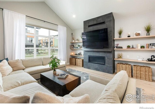 730 Promenade Dr, Superior, CO 80027 - living area featuring a fireplace, vaulted ceiling, wood finished floors, and recessed lighting