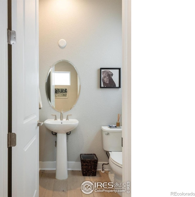 730 Promenade Dr, Superior, CO 80027 - bathroom featuring toilet, baseboards, and wood finished floors