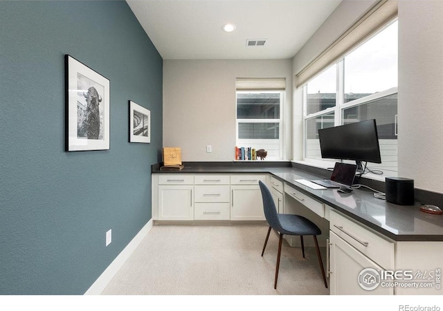 730 Promenade Dr, Superior, CO 80027 - office area featuring light carpet, built in desk, baseboards, and a textured wall