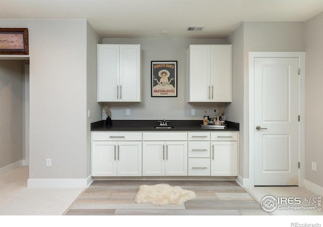 730 Promenade Dr, Superior, CO 80027 - kitchen with a sink, dark countertops, and white cabinets