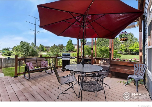 633 Deerwood Dr, Longmont, CO 80504 - wooden deck featuring a grill and outdoor dining space