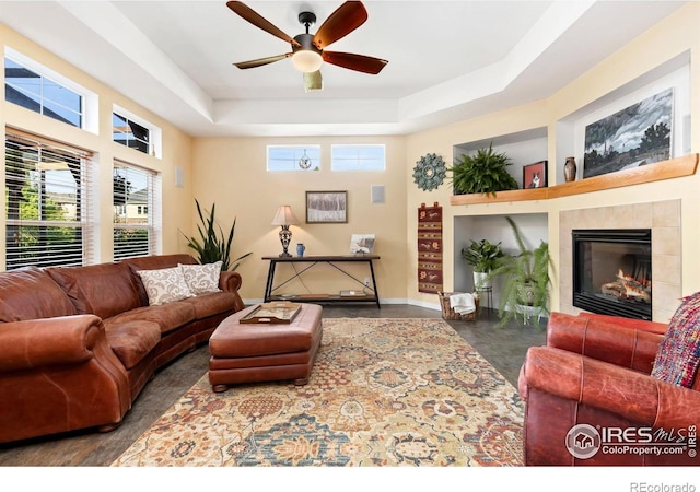 633 Deerwood Dr, Longmont, CO 80504 - living room with a raised ceiling, a ceiling fan, and a tiled fireplace