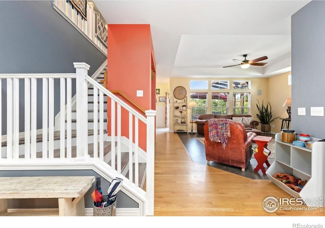 633 Deerwood Dr, Longmont, CO 80504 - staircase featuring a ceiling fan, wood finished floors, and a tray ceiling