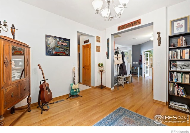 633 Deerwood Dr, Longmont, CO 80504 - workout room featuring light wood-style flooring and a chandelier