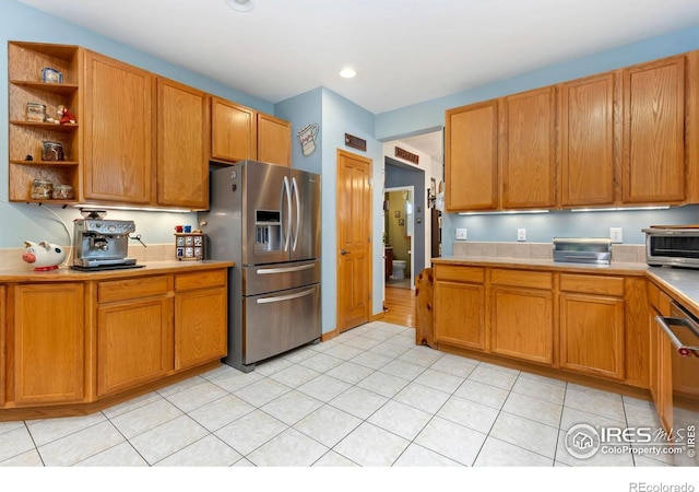 633 Deerwood Dr, Longmont, CO 80504 - kitchen with appliances with stainless steel finishes, open shelves, light countertops, light tile patterned flooring, and brown cabinetry