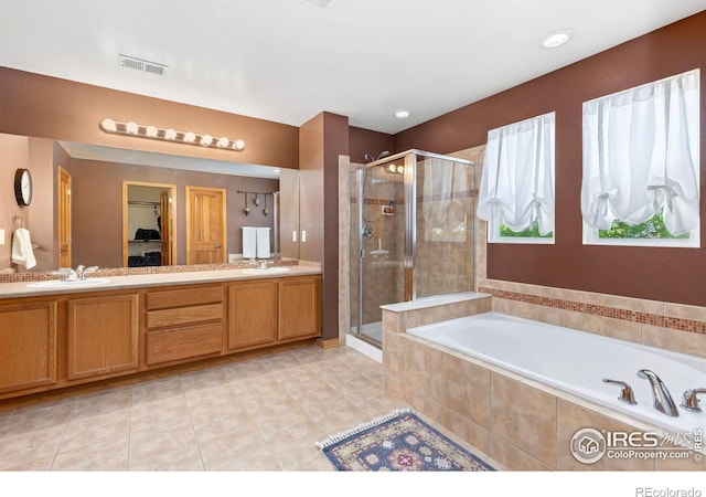 633 Deerwood Dr, Longmont, CO 80504 - bathroom with a stall shower, a garden tub, double vanity, tile patterned floors, and a closet