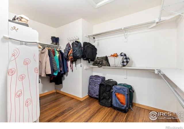 633 Deerwood Dr, Longmont, CO 80504 - spacious closet featuring wood finished floors and attic access
