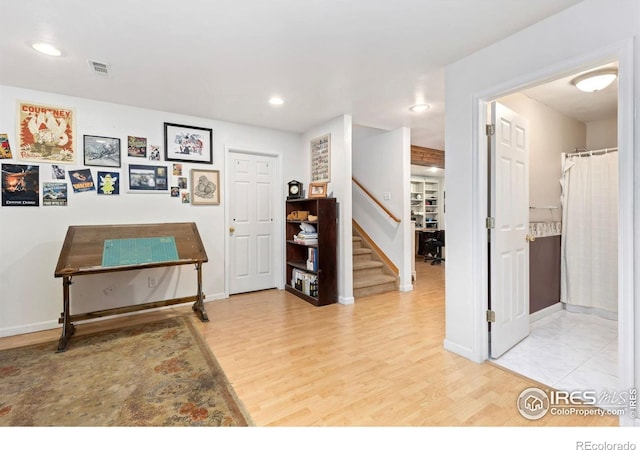 633 Deerwood Dr, Longmont, CO 80504 - hall with wood finished floors, stairway, and recessed lighting