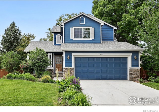 823 Timothy Dr, Longmont, CO 80503 - view of front of home featuring concrete driveway, a garage, stone siding, and roof with shingles
