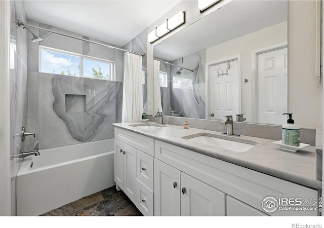 823 Timothy Dr, Longmont, CO 80503 - full bathroom featuring shower / bath combination with curtain, double vanity, and stone tile floors