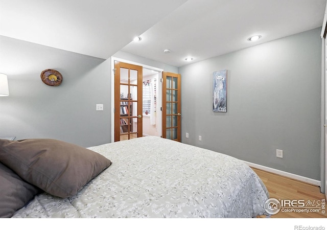 823 Timothy Dr, Longmont, CO 80503 - bedroom with french doors, wood finished floors, and baseboards