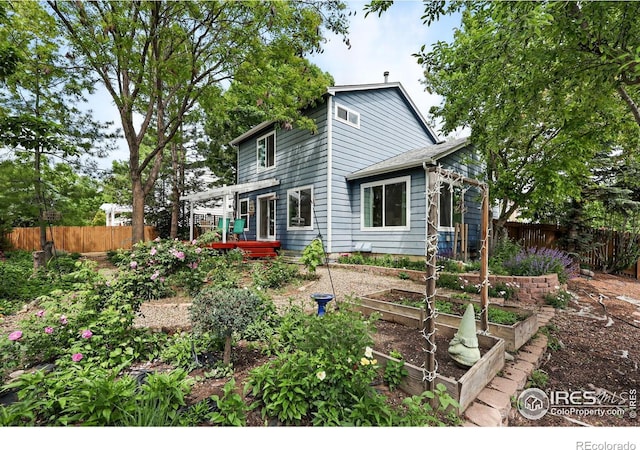 823 Timothy Dr, Longmont, CO 80503 - rear view of property with a vegetable garden and a pergola
