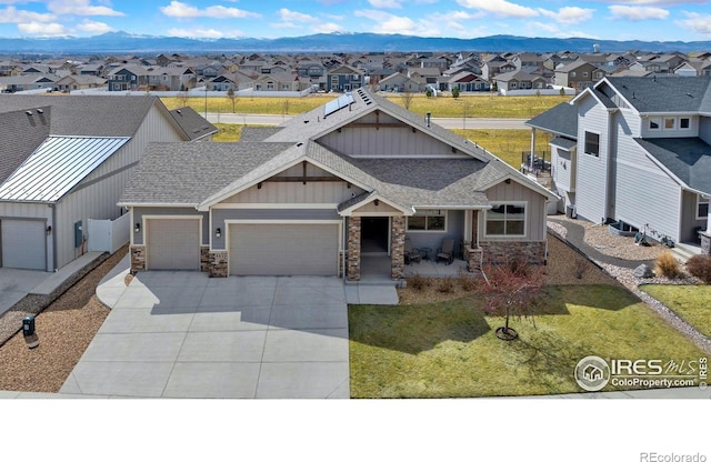 5532 Maidenhead Dr, Windsor, CO 80550 - view of front of home with a residential view, board and batten siding, stone siding, and a shingled roof