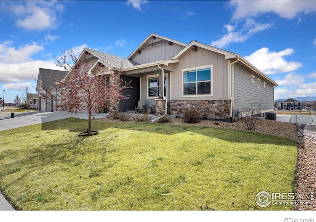 5532 Maidenhead Dr, Windsor, CO 80550 - craftsman-style home with driveway, a front yard, stone siding, an attached garage, and board and batten siding