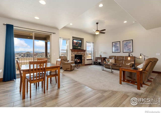 5532 Maidenhead Dr, Windsor, CO 80550 - living area with light wood-style floors, a ceiling fan, a stone fireplace, and recessed lighting