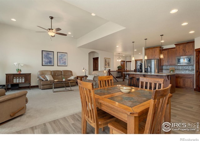 5532 Maidenhead Dr, Windsor, CO 80550 - dining space with recessed lighting, a ceiling fan, arched walkways, and light wood-style flooring