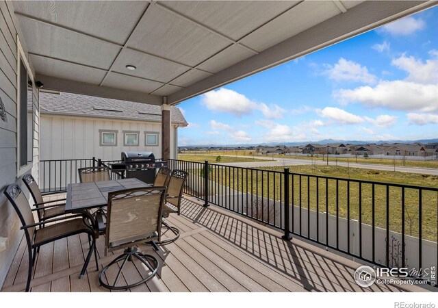 5532 Maidenhead Dr, Windsor, CO 80550 - wooden terrace with grilling area and outdoor dining space