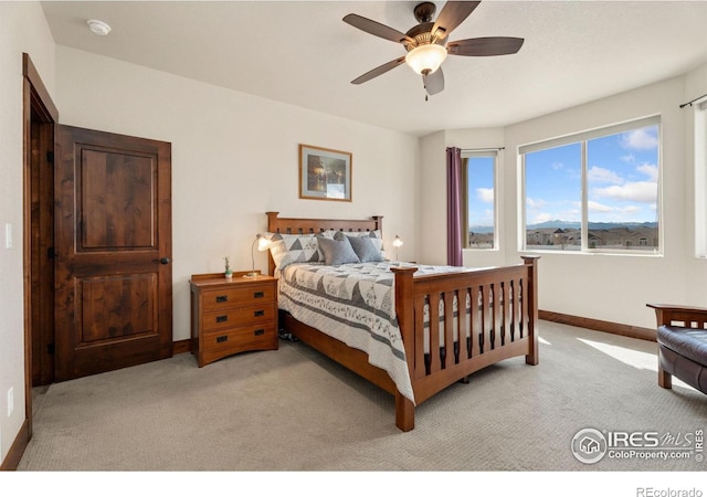 5532 Maidenhead Dr, Windsor, CO 80550 - bedroom with light colored carpet, baseboards, and ceiling fan