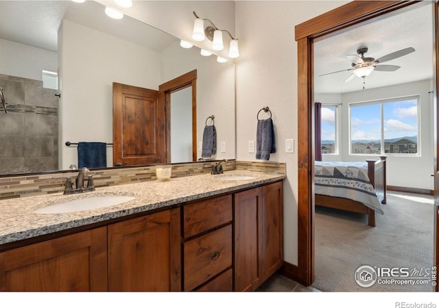 5532 Maidenhead Dr, Windsor, CO 80550 - bathroom featuring tasteful backsplash, double vanity, a ceiling fan, ensuite bathroom, and baseboards