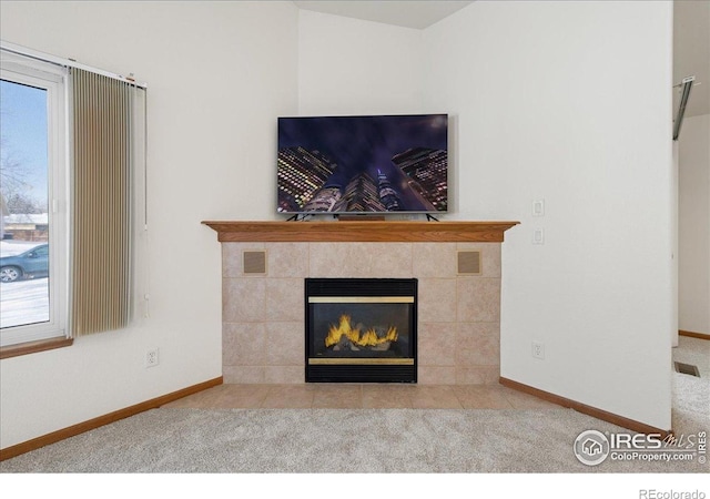 2615 Anemonie Dr, Loveland, CO 80537 - detailed view of a tile fireplace, baseboards, and carpet flooring