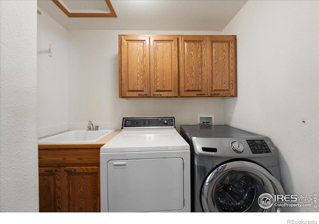 2615 Anemonie Dr, Loveland, CO 80537 - washroom featuring washing machine and clothes dryer, cabinet space, and attic access