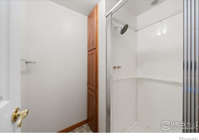 2615 Anemonie Dr, Loveland, CO 80537 - bathroom featuring a shower and baseboards