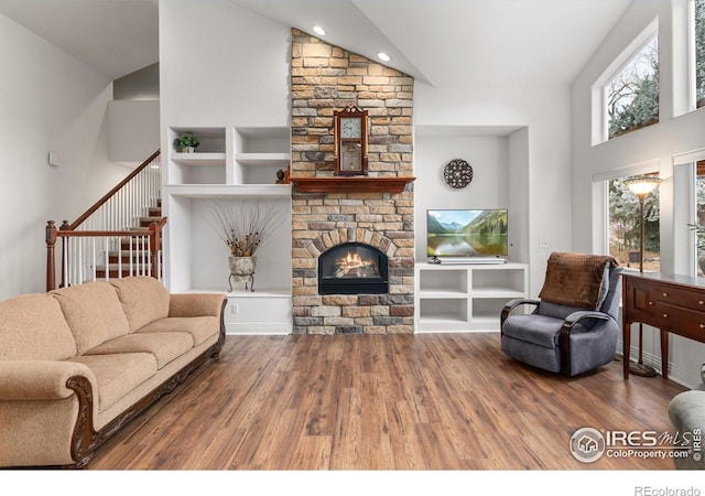 2549 Cowley Dr, Lafayette, CO 80026 - living room with a fireplace, wood finished floors, stairway, recessed lighting, and a high ceiling