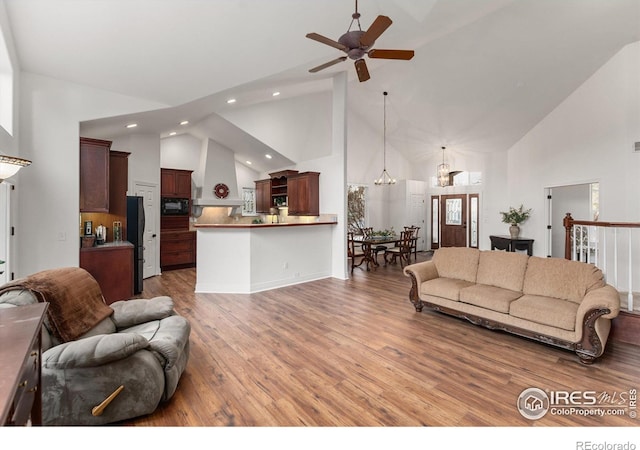 2549 Cowley Dr, Lafayette, CO 80026 - living area with high vaulted ceiling, recessed lighting, light wood-type flooring, a ceiling fan, and a chandelier