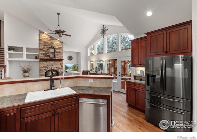 2549 Cowley Dr, Lafayette, CO 80026 - kitchen with appliances with stainless steel finishes, a sink, ceiling fan, open floor plan, and light wood-type flooring