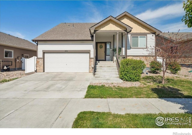 1801 102nd Ave, Greeley, CO 80634 - ranch-style home featuring stone siding, a garage, driveway, and board and batten siding