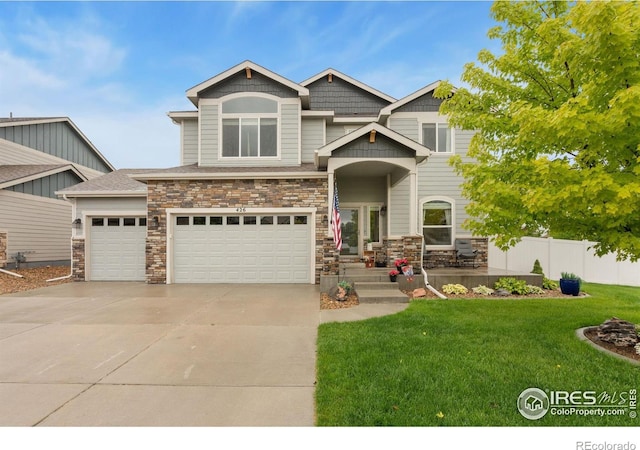 426 Gannet Peak Dr, Windsor, CO 80550 - craftsman-style home featuring concrete driveway, stone siding, and an attached garage