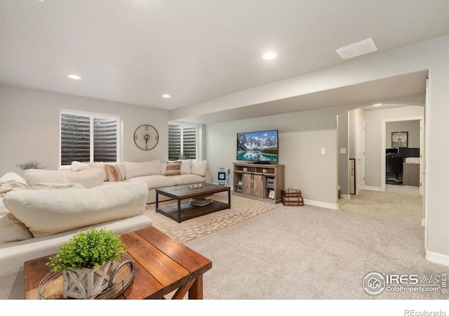 426 Gannet Peak Dr, Windsor, CO 80550 - living room featuring recessed lighting, carpet, baseboards, and arched walkways