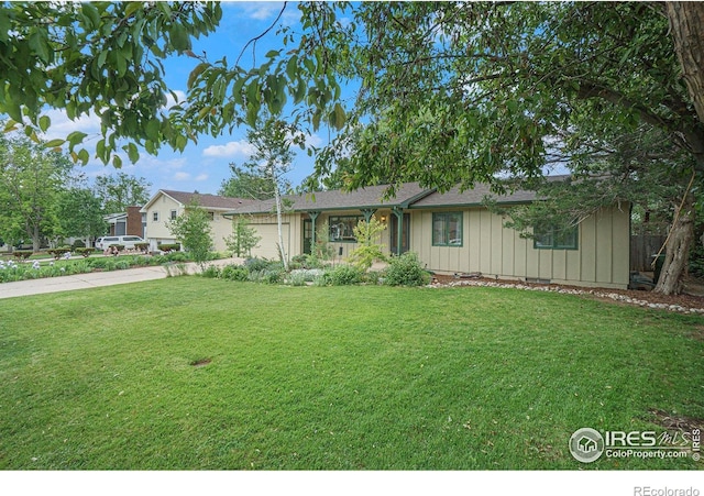 2420 Sheffield Cir E, Fort Collins, CO 80526 - single story home with concrete driveway, board and batten siding, a front yard, and a garage