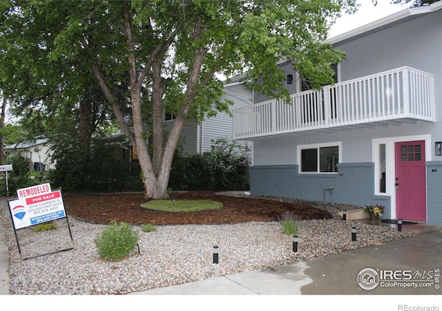 1714 Zeus Dr, Lafayette, CO 80026 - view of front of house featuring a balcony and brick siding