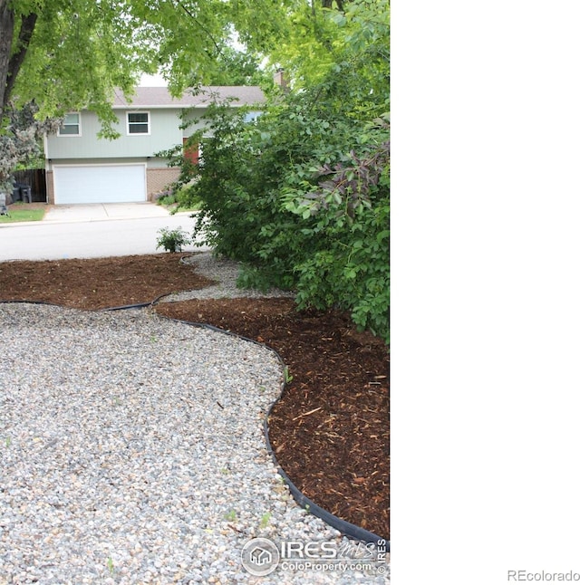 1714 Zeus Dr, Lafayette, CO 80026 - view of yard featuring concrete driveway and an attached garage