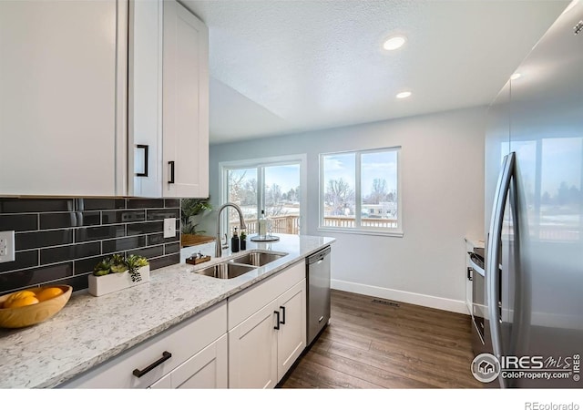1714 Zeus Dr, Lafayette, CO 80026 - kitchen featuring a sink, stainless steel appliances, baseboards, dark wood-style floors, and white cabinets
