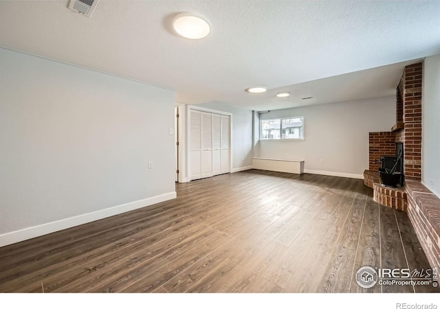 1714 Zeus Dr, Lafayette, CO 80026 - unfurnished living room with hardwood / wood-style flooring, baseboards, and a textured ceiling
