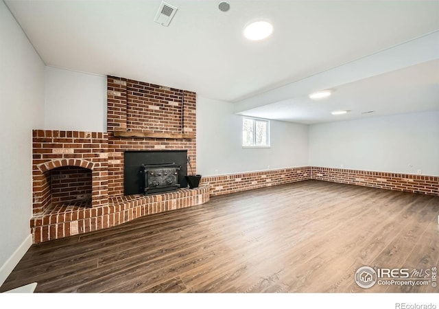 1714 Zeus Dr, Lafayette, CO 80026 - unfurnished living room with wood finished floors and a wood stove