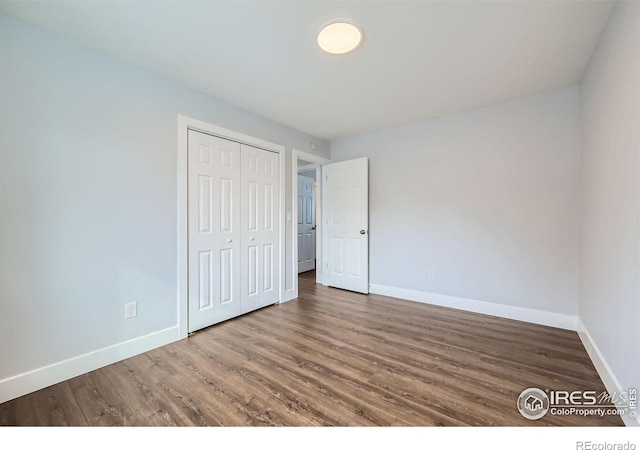 1714 Zeus Dr, Lafayette, CO 80026 - unfurnished bedroom with baseboards, wood finished floors, and a closet