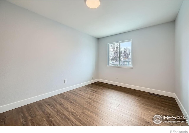 1714 Zeus Dr, Lafayette, CO 80026 - unfurnished room featuring baseboards and dark wood-style flooring