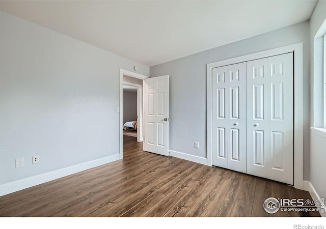 1714 Zeus Dr, Lafayette, CO 80026 - unfurnished bedroom with wood finished floors, baseboards, and a closet